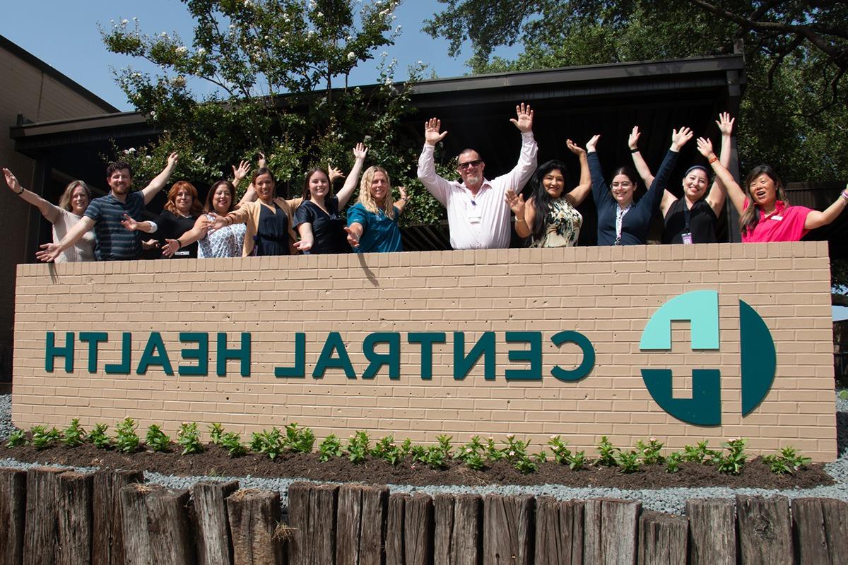 employees behind Central Health sign